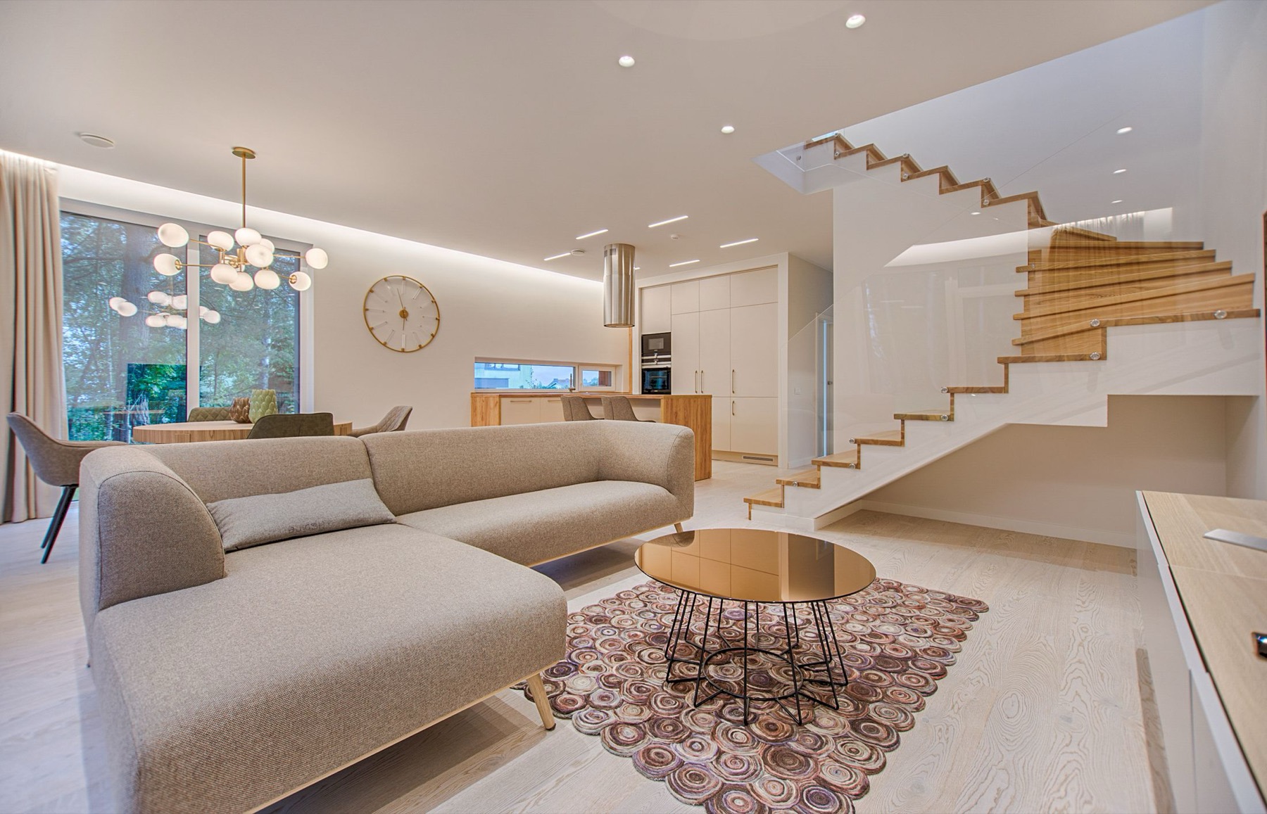A bright, open-plan remodeled home interior with a staircase — the standard of finish Metanoia Contracting works to